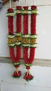 Wedding ceremony ritual traditional jaimala with fresh red roses for bride and groom