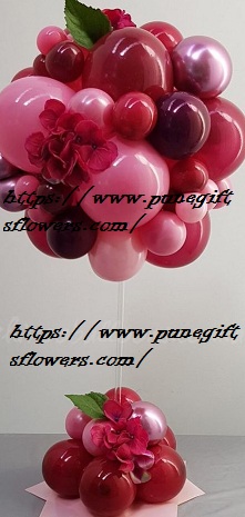 Decorated small and large ballloons 40 balloons shades of pink at bottom and flowers with shades of pink balloons cluster on top of 2 stick